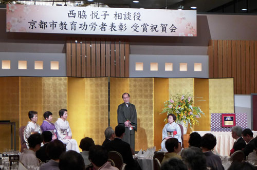 地域女性会 西脇 悦子 相談役　市教育功労者表彰受賞祝賀会　笹岡さんの華包みを贈呈